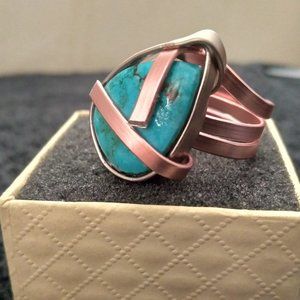 Imported turquoise set in copper and silver anodised aluminum setting